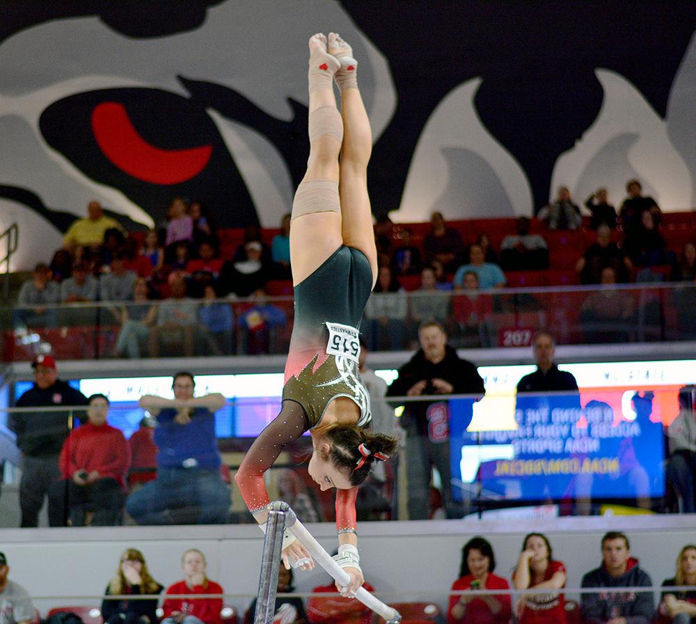 Senior Nicole Wild balances herself on the bars in the NCAA Regional Championship at Reynolds Coliseum on Saturday. She scored 9.750 in this event.