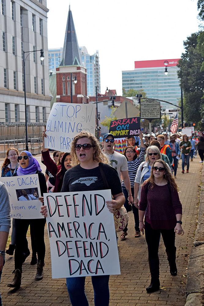 Marchers make their way to Halifax Mall to defend DACA on Sunday following Trump's decision to end the program. Speakers included those who depend on DACA, and Congressman Price, who condemned the president's actions. The event was organized by two NC State students, which took place on the major streets of downtown.