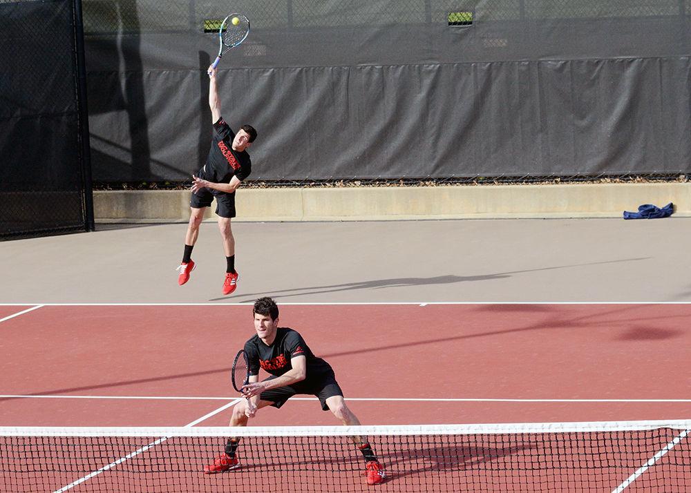 Juniors Igor and Ivan Saveljic serve to the Duke doubles team during the tennis match on March 16. The brothers lost their doubles match, and Ivan moved on to a singles match which he lost as well. Wolfpack was defeated by Duke with an overall score of 1-6.