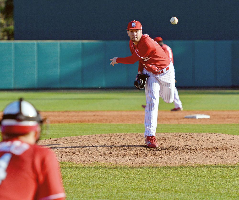 Brian Brown, a then-sophmore pitcher, warms up between innings during the game against Wright State. Brown only allowed three hits and two walks during the game on Saturday, Feb. 27, 2016 at Doak Field at Dail Park, allowing the Wolfpack to win 6-1.