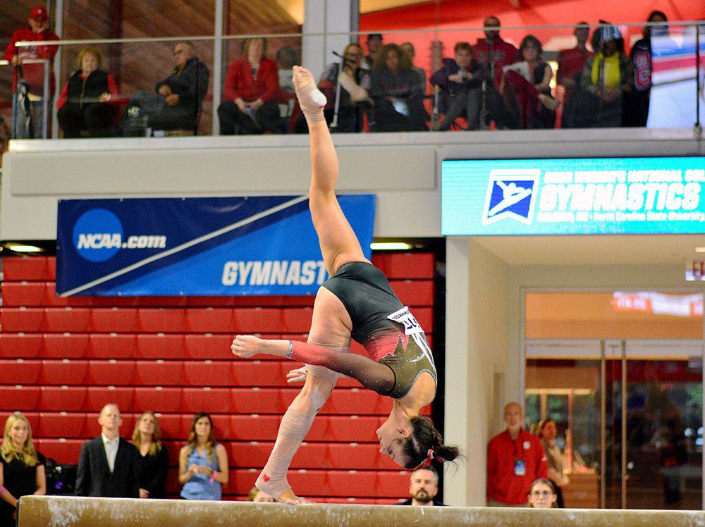 Senior Nicole Wild performs on the beam in the NCAA Regional Championship in Reynolds Coliseum on Saturday. She scored 9.825 in this event, making her the highest scorer on her team for beam.