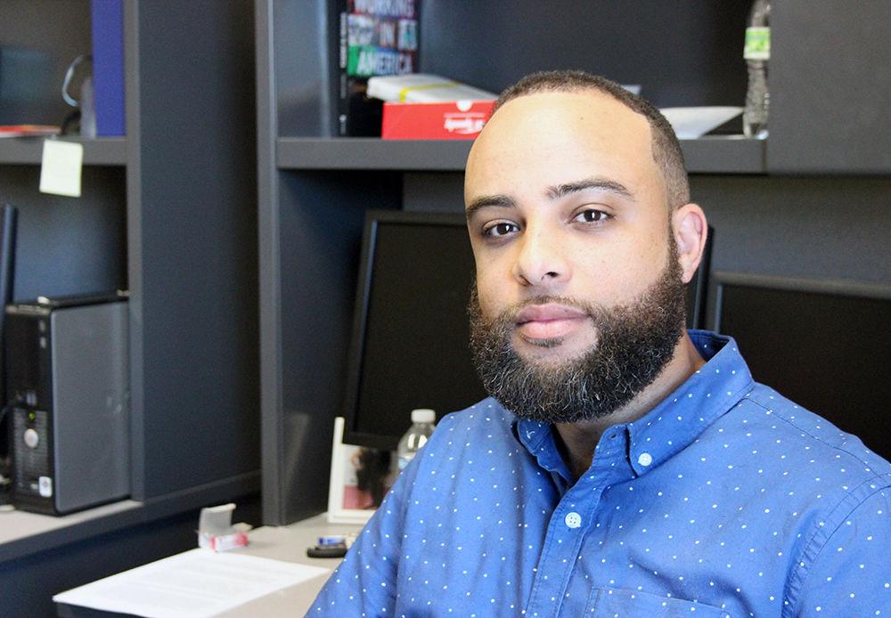 Taurean Brown, a graduate student in the department of sociology and anthropology, sits in his office in the 1911 Building on Tuesday. Brown specializes in inequality of race, class and gender. His Twitter account @SankofaBrown has garnered over 60,000 followers where he speaks about related social issues.