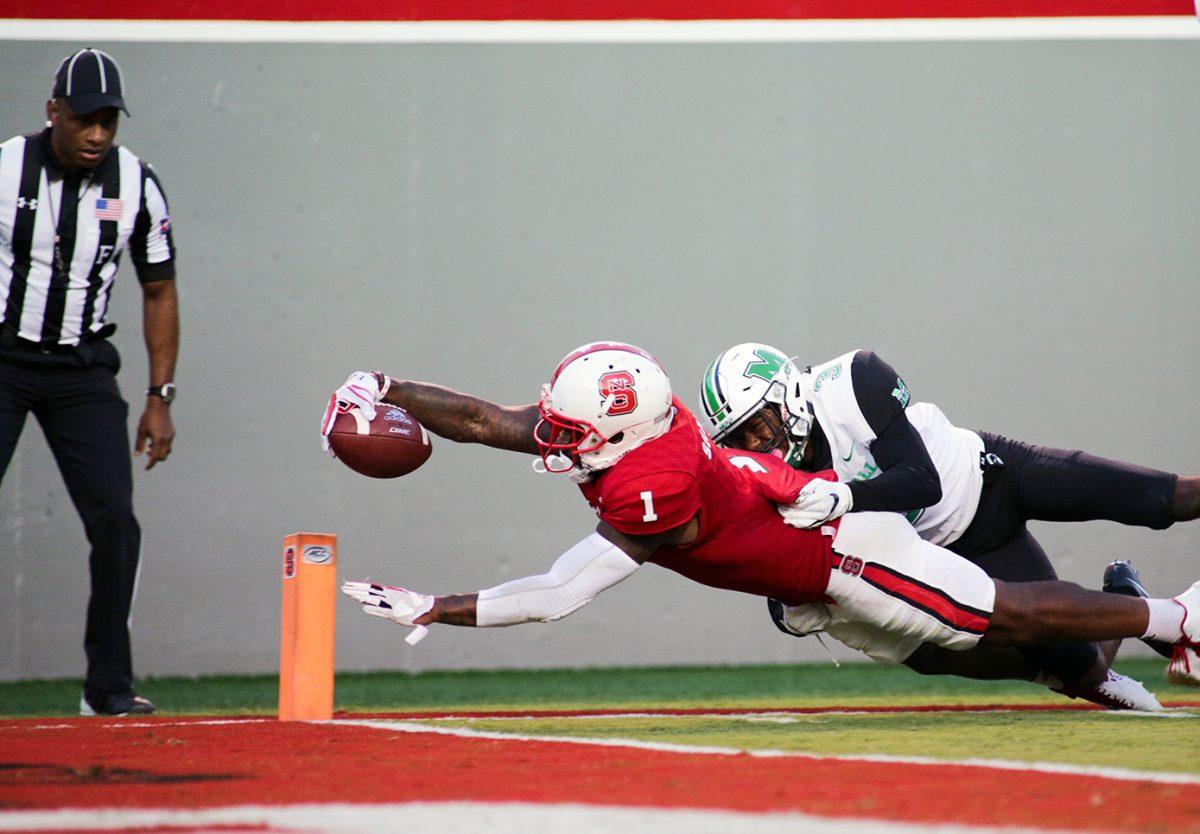 Senior halfback Jaylen Samuels stretches for the end zone and a touchdown during the 37-20 win over Marshall on Saturday in Carter-Finley Stadium.