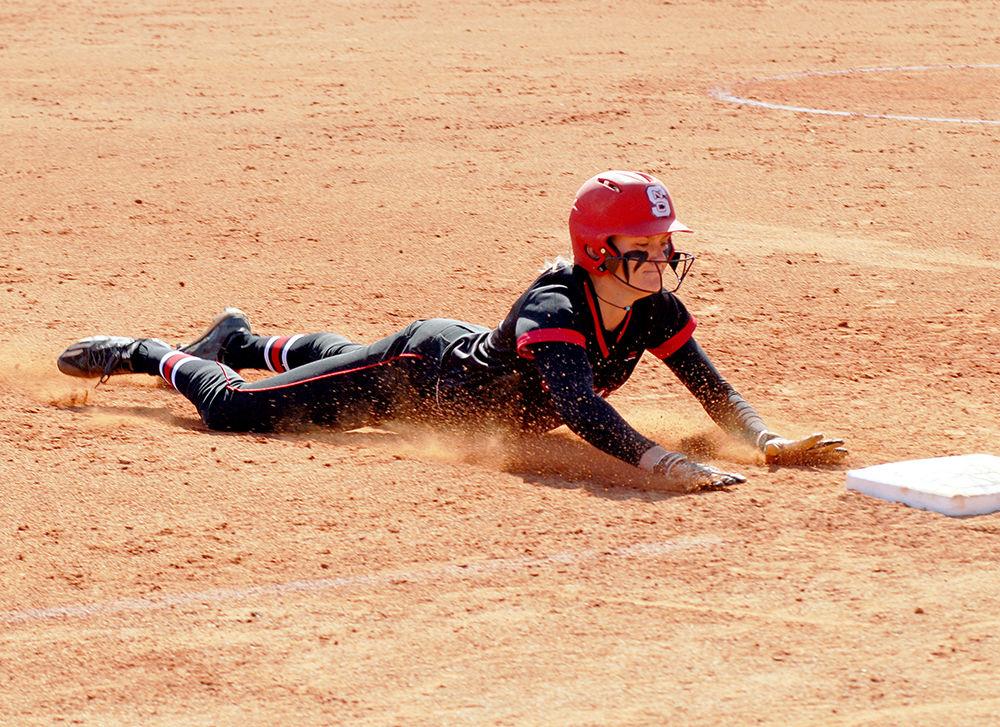 Sophomore outfielder Jade Caraway slides towards third base at the NC State vs. Niagara softball match at Dail Softball Stadium on March 23. The Wolfpack won the match against the Eagles 9-1.