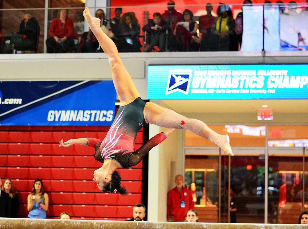 Senior Nicole Wild performs on the beam in the NCAA Regional Championship in Reynolds Coliseum on Saturday. She scored 9.825 in this event, making her the highest scorer on her team for beam.