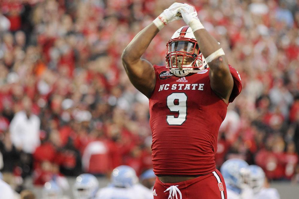 Senior defensive end Bradley Chubb motions for the crowd to get on their feet and cheer at the N.C. State vs. UNC Chapel Hill football game in Carter-Finley Stadium on Saturday, Nov. 25, 2017. The Wolfpack won against the Tar Heels 21-33, claiming their eighth win of the season.