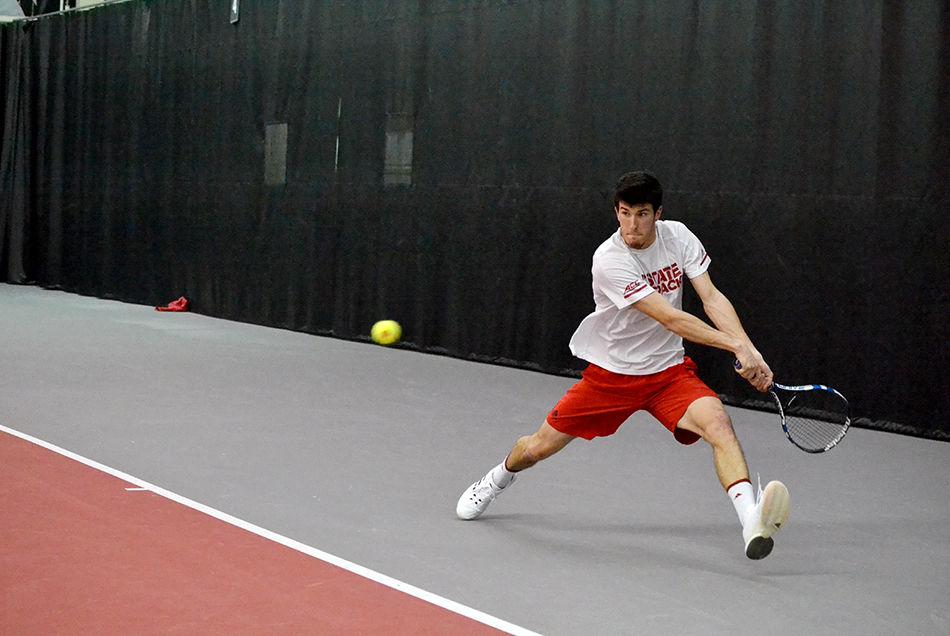 Igor Saveljic, a third-year from Montenegro, returns a volley from Elon during a doubles men's tennis match on Friday, Feb. 9 in the Andy Andrews Indoor Tennis Stadium. Despite losing his doubles match, Saveljic went on to win his singles matches, helping to bring home a 6-1 win for the Wolfpack.