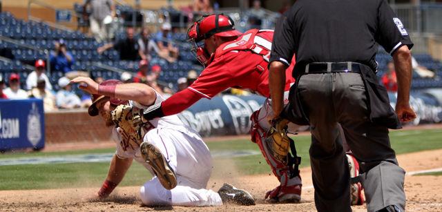 Junior catcher Andrew Knizner lays a tag on a Florida State runner at home plate at the Durham Bulls Athletic Park on May 25. Knizner had 2 hits and one walk during the game. The Wolfpack lost the game to the Florida State Seminoles 7-3.