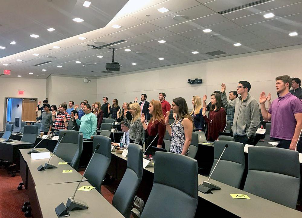 Senators take the Senatorial Oath in the first meeting of the 98th session in Student Governance Chambers on Wednesday.