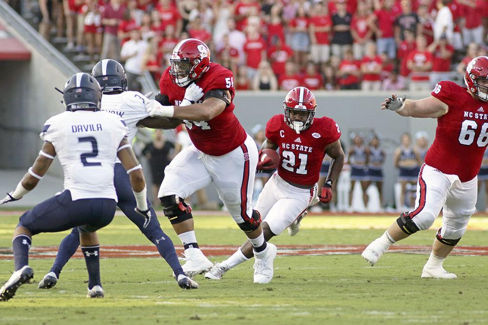Senior running back Matt Dayes cuts back into the hole as he gets a block from redshirt sophomore offensive tackle Will Richardson in the Wolfpack's game against Old Dominion University on Sept. 17, 2016. Dayes caught 4 passes for 49 yards, rushed for 72 yards on 14 carries and had 1 touchdown in the 49-22 win at Carter-Finley Stadium.