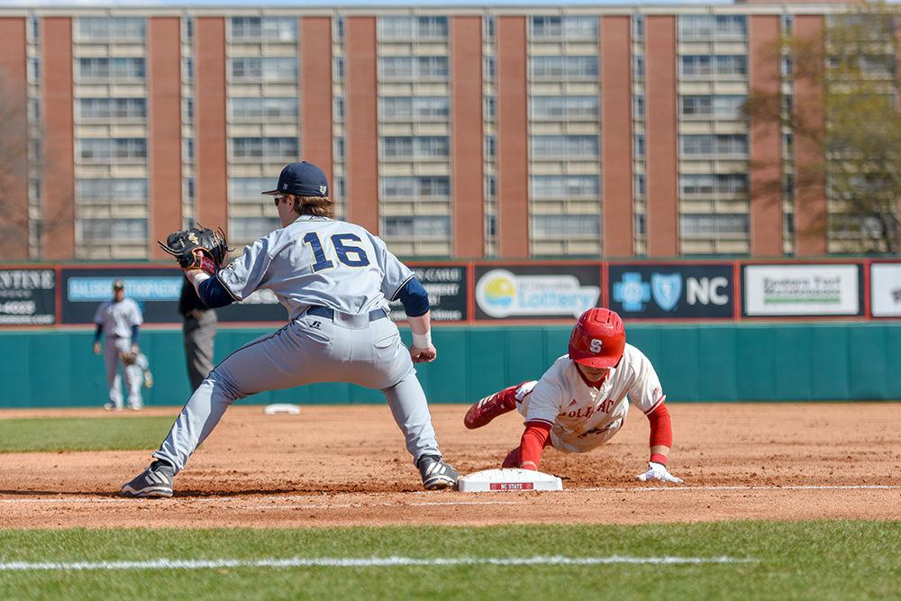 Senior outfielder Josh McLain slides back to first base after attempting to steal to second during the double-header game versus Georgia Tech on Friday, March 23, 2018 in Doak Field at Dail Park. Although losing 13-4 to the Yellow Jackets in the first game, the Wolfpack came back to win the second match-up 5-2.