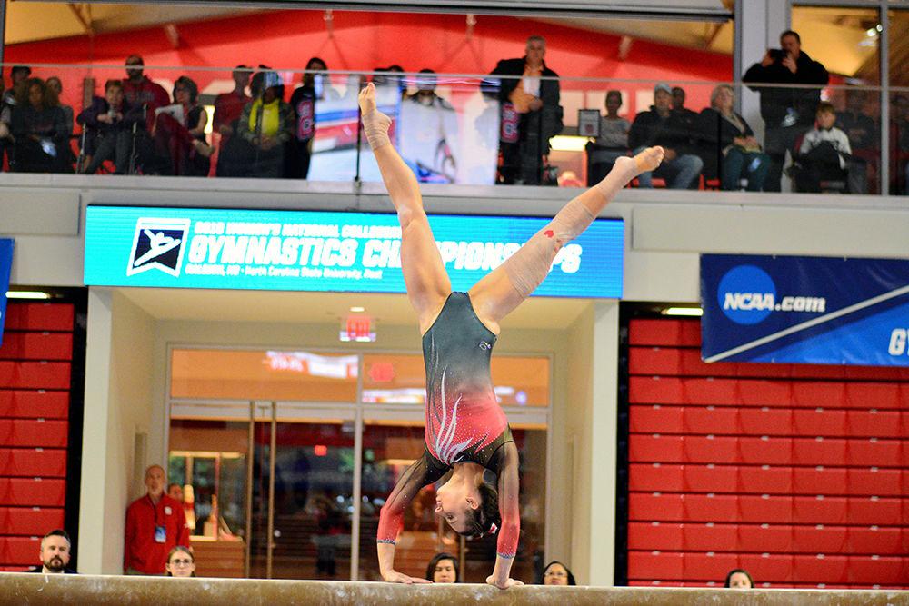 Senior Nicole Wild performs on the beam in the NCAA regional championship in Reynolds Coliseum on Saturday. She scored 9.825 in this event, making her the highest scorer on her team for beam.