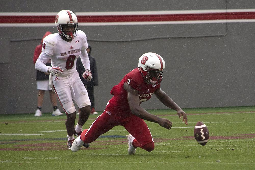 Junior wide receiver Kelvin Harmon falls victim to the wet conditions, leading to an incomplete reception during the Kay Yow Spring Game in Carter-Finley Stadium, Saturday, April 7.&#160;