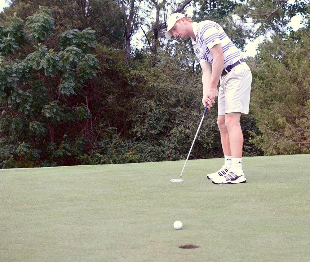 Men's golf team member Stephen Franken, a third-year studying business administration, warms up before practice at the Lonnie Poole Golf Course on Sept. 14, 2017. "We practice six days a week," Franken said.