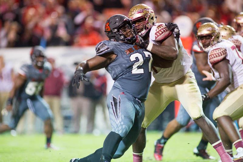 Then-junior defensive tackle Justin Jones forces his way past the Florida State offensive line. The Wolfpack fell in a 24-20 loss to Florida State on Saturday in Carter-Finley Stadium.