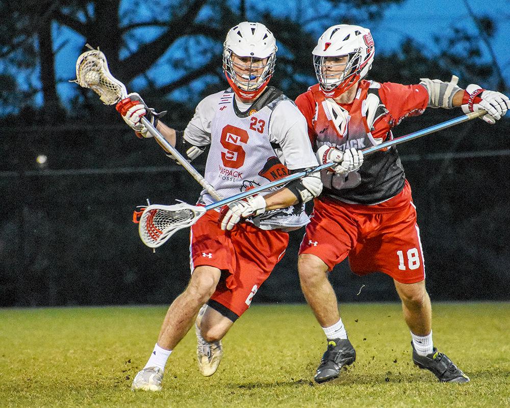 Senior attacker Miller Barbour and senior defender Jack Sarle clash during the Men&#8217;s Club Lacrosse practice on Wednesday, March 28 at Method Road Fields. The lacrosse team fell 9-5 to the Clemson Tigers on Saturday making their record 2-8-1.