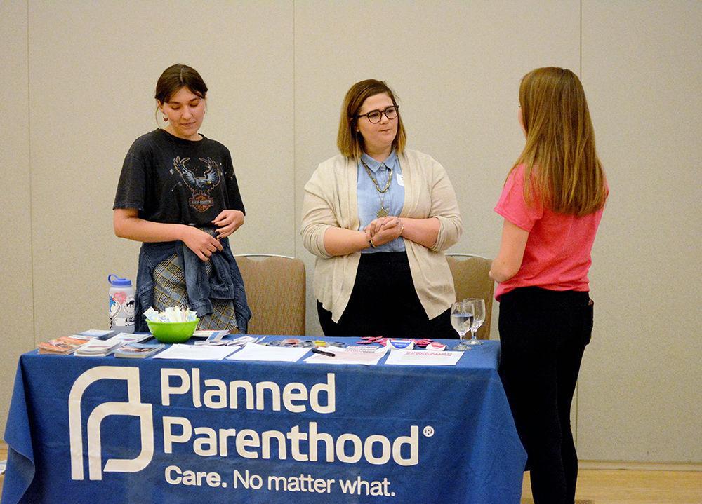 Planned Parenthood Generation Action members Karsin Williard, a fourth-year studying political science and the vice president of the network, Kat Kirby, a third-year studying interdisciplinary studies, and Emily Walter, a fourth-year studying political science and the president of the network, work at a table during the 2018 Gender and Equity Research Symposium. The symposium took place in Talley Student Union on April 2, 2018.
