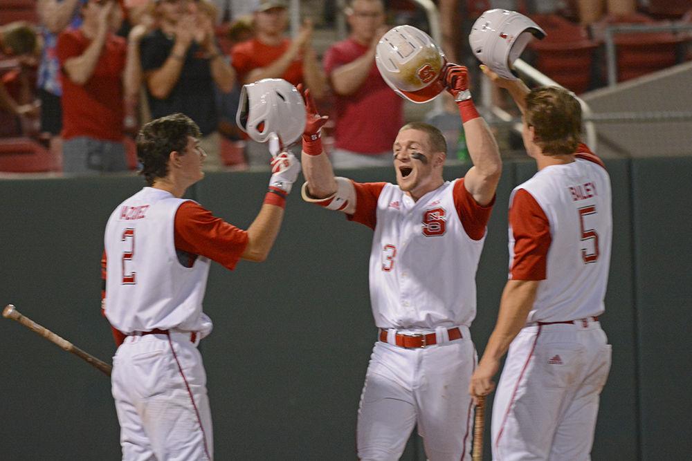 Senior outfielder Brock Deatherage celebrates one of his two home runs of the night with his teammates on Saturday at Doak Field. Deatherage went 2-4 with 4 RBIs as the Wolfpack beat William &amp; Mary 8-4.