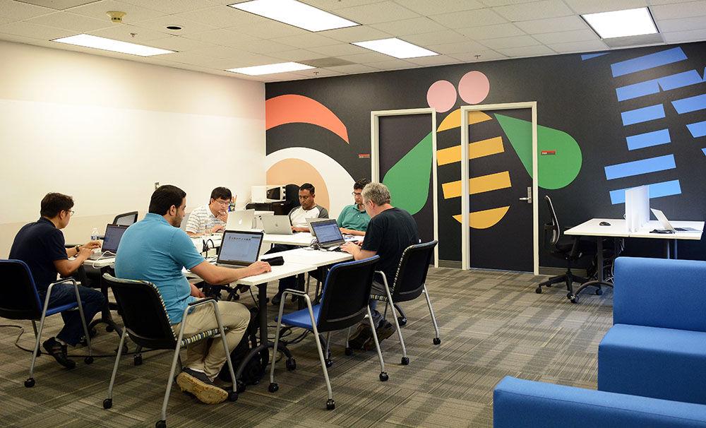 Various employees and NC State graduate students work together in the IBM Education Innovation Center on the third floor of Research IV on Centennial Campus on Wednesday, May 16, 2018. Dr. Andy Rindos, an IBM employee, said that the center works to facilitate collaborative meetings and the company's existing partnership with NC State. In the fall of 2018, NC State will gain access to a quantum computing network through IBM Q.