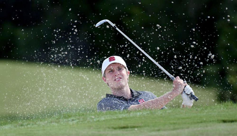 Junior Harrison Rhoades lays up a shot from a bunker in the NCAA Austin Regional at the University of Texas Golf Club on May 16, 2017.