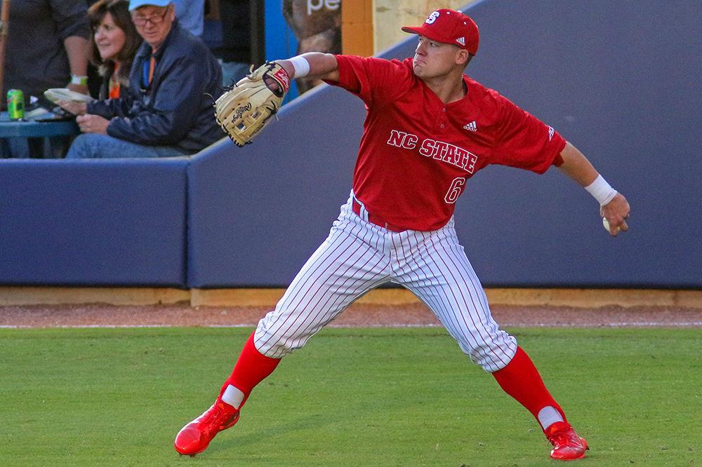 Junior outfielder Brett Kinneman fields the ball against UNC at the Durham Bulls Athletic Park on Tuesday, April 17. The Wolfpack ended up with an 8-3 win.