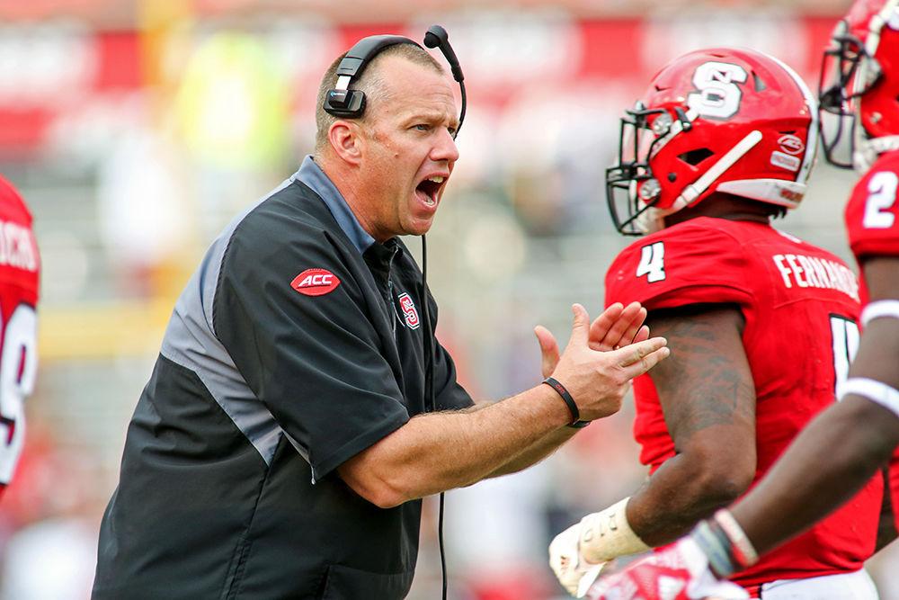 Head coach Dave Doeren tells the defense "good job" as they come off the field after preventing a Miami touchdown. The error-prone Wolfpack fell to Maimi 27-13 on Nov. 19, 2016 at Carter-Finley Stadium.