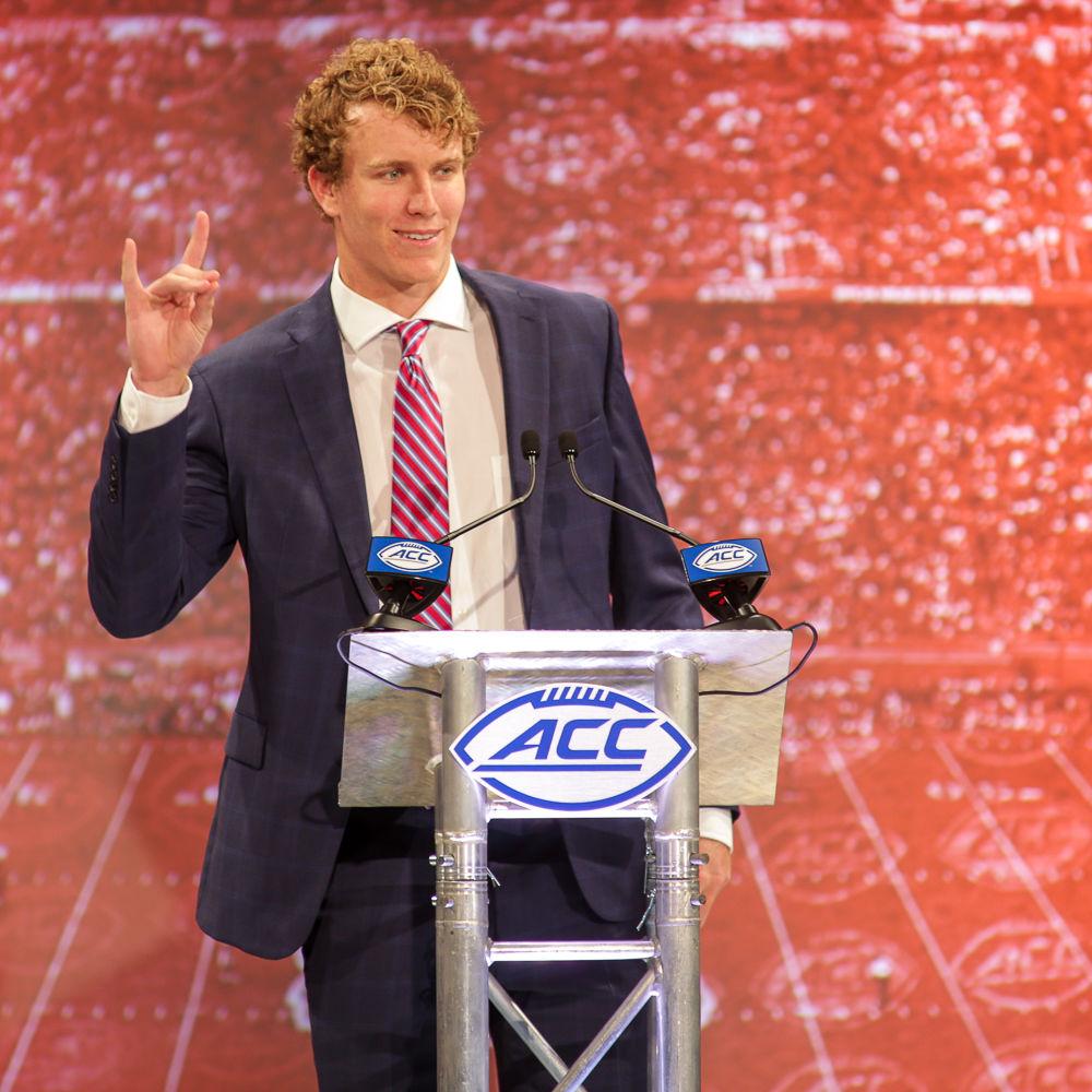 Graduate quarterback Ryan Finley holds up a wolfie before taking questions at the ACC Kickoff in Charlotte on Thursday, July 19.