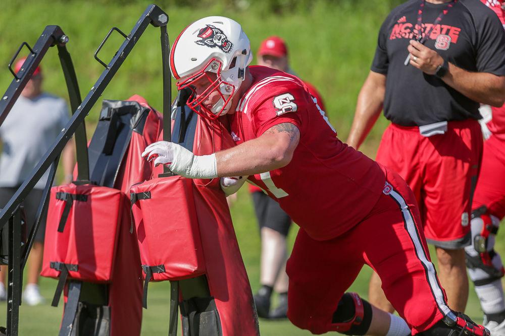 Redshirt sophomore guard Justin Witt pushes the sled during practice on Thursday morning.