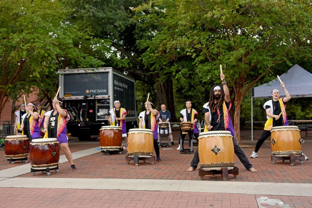 Members of Triangle Taiko of North Carolina play their drums during Packapalooza 2018 on Hillborough St. on Saturday, Aug. 25.