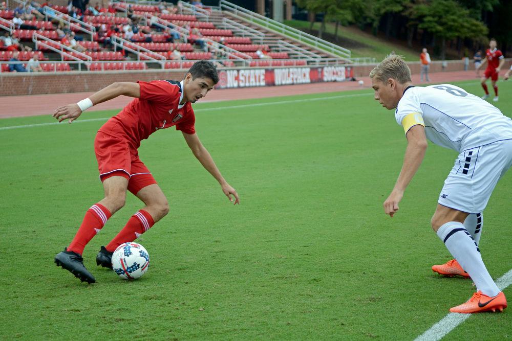 Freshman forward Manny Perez runs while dribbling the ball around an LIU Brooklyn player. The NC State men's soccer team was winning 1-0 on Sep. 1, 2017 against LIU Brooklyn at Dail Soccer Stadium before suspension due to inclement weather.