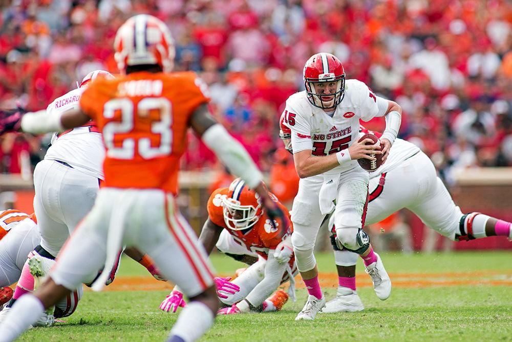 Graduate quarterback Ryan Finley runs the ball upfield against Clemson. The Wolfpack lost 24-17 in overtime on Oct. 15, 2016.
