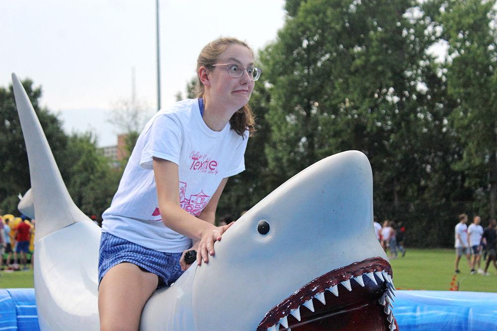 Haley Bourhill, a first-year studying human biology, rides a mechanical shark at this year's RecFest, on Aug. 19. When asked about the event, she said, "I was glad I came, I wasn't expecting it to be so many people." Held at Miller Fields, this event is sponsored by NC State Wellness and Recreation and is one of the year's largest events.