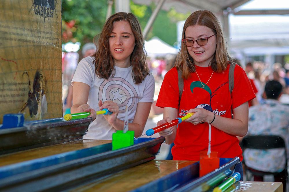 Sarah Vaccarella, a first year studying biological sciences, and Kaitlyn Stewart, a first year studying psychology, take part in a boat race in the arts tent at Packapalooza on Saturday, August 25. The boat race is part of University Theater's promotion of Men on Boats.