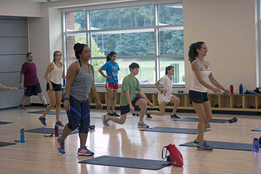 Students warm up for a fitness class in Carmichael Recreation Center on Aug. 14, 2017. The gymnasium holds a variety of classes all week ranging from yoga to cycling.