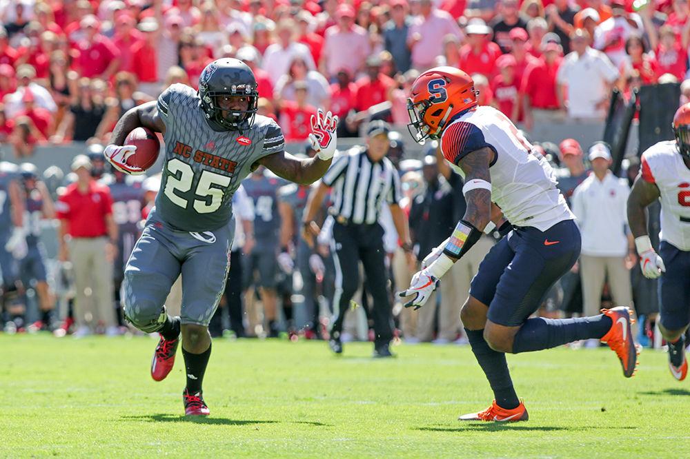Junior running back Reggie Gallaspy Jr. prepares a stiff arm as he runs the ball. Gallaspy Jr. had 36 yards on 10 carries as the Wolfpack took down Syracuse on Sept. 30, 2017 at Carter-Finley Stadium.
