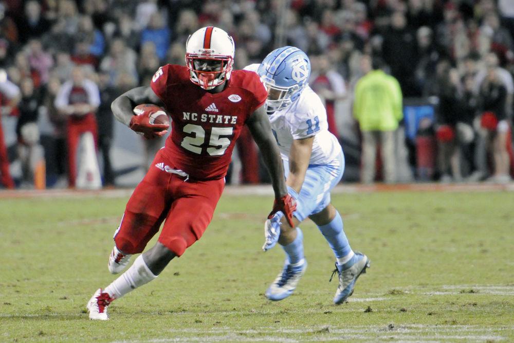 Junior running back Reggie Gallaspy II runs the ball down the field against UNC at Carter-Finley Stadium on Nov. 25. The Wolfpack won against the Tar Heels 33-21, claiming their eighth win of the season.