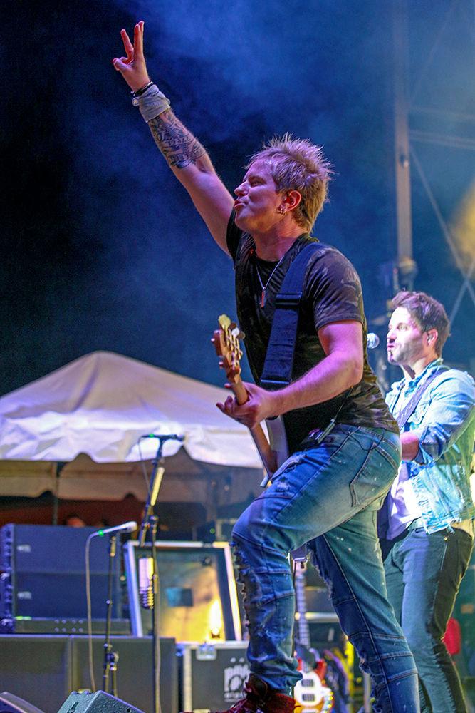Bassist Barry Knox of Parmalee gives the crowd a one two three count before hitting the bass again during the closing concert of Packapalooza on Saturday, August 25.