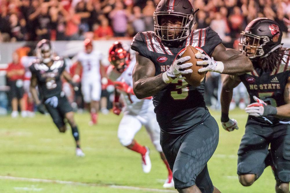 Redshirt junior linebacker Germaine Pratt returns an interception for a touchdown in the 39-25 win over Louisville in Carter-Finley Stadium on Thursday, October 5.