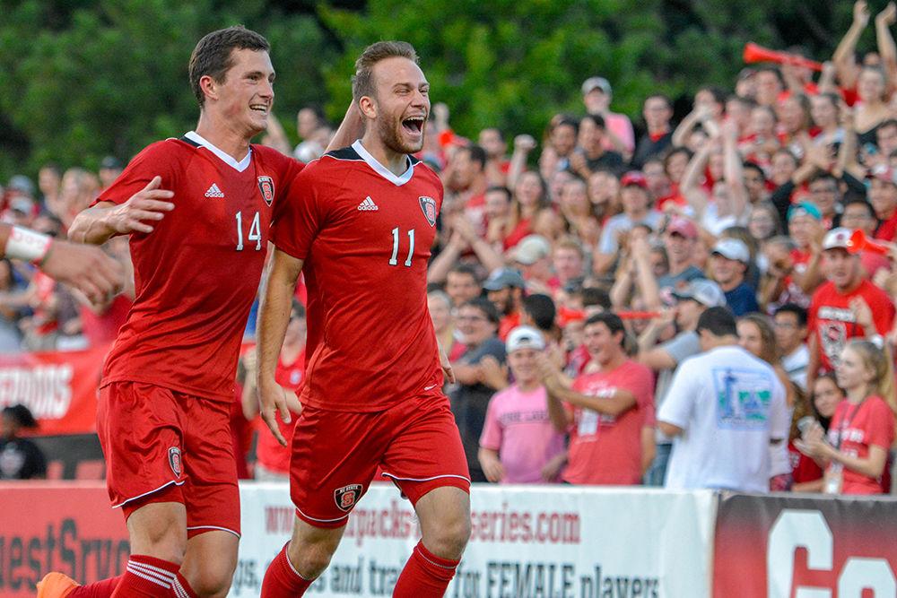 Junior midfielder Tyler Gabarra celebrates with senior forward Cjay Sparks after Gabarra scores a goal in the 31st minute in the game versus USC Upstate on Friday at Dail Soccer Field. The Wolfpack beat the Spartans 3-1.