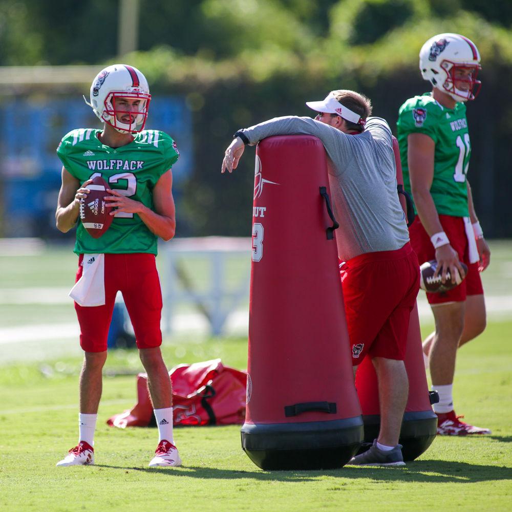 Offenisve coordinator Eliah Drinkwitz talks redshirt freshman quarterback Jory Perkins before running a drill at practice on Thursday morning.