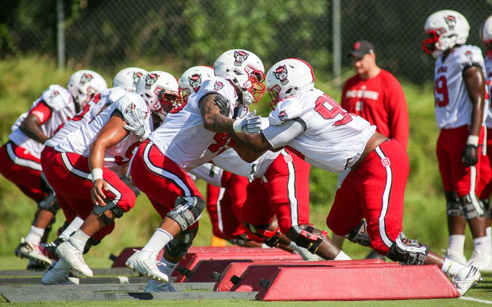 The defensive line runs a drill during Thursday morning's practice.