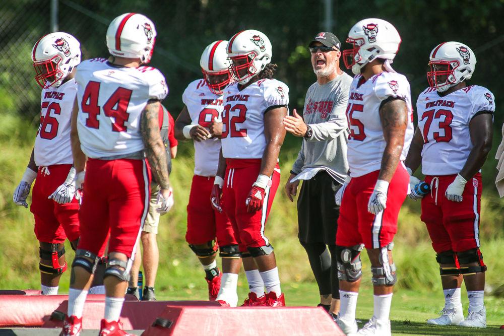 Defensive line coach Kevin Patrick talks to his players between reps of a drill during Thrusday morning's practice.