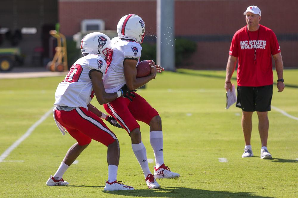 Freshman nickelback Tanner Ingle blocks junior cornerback Nick McCloud during a drill at Thursday morning's practice.