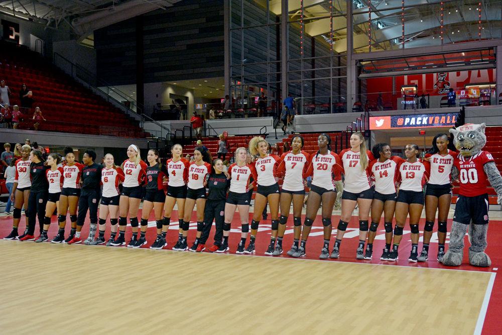 The Wolfpack Women's Volleyball Team celebrates winning the game. The team had 6 total aces, versus Campbell's 3. NC State defeated Campbell University 3-0 at Reynolds Coliseum on Sunday, Sept. 9.
