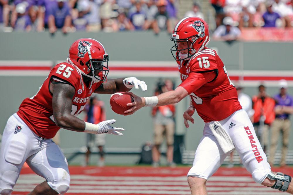 Graduate quarterback Ryan Finley hands off to senior running back Reggie Gallaspy Jr. on Saturday, Sept. 1 at Carter-Finley Stadium. Gallaspy had 68 yards in the 24-13 win over James Madison.