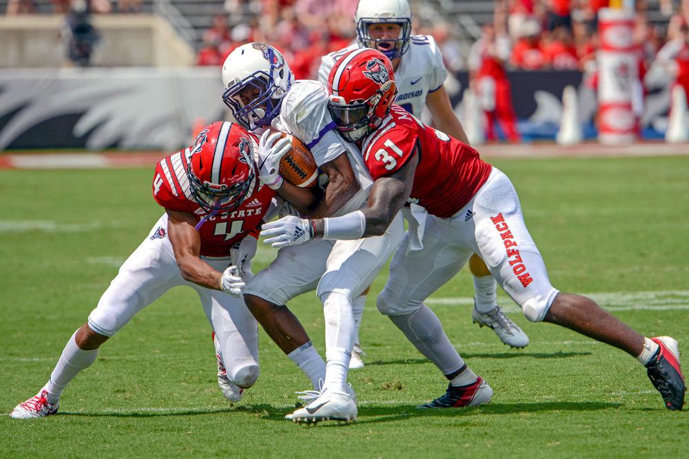 Junior cornerback Nick McCloud and redshirt junior safety Jarius Morehead combine for a tackle against James Madison on Saturday, Sept. 1 at Carter Finley Stadium. The Wolfpack beat James Madison 24-13.