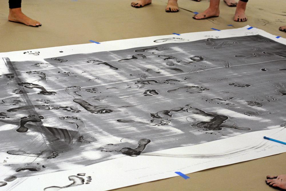 Members of NCSU Dance Company survey their execution of "John Cage's STEPS: A Composition For A Painting" for a Master Class in Carmichael Gymnasium on Wednesday, Sept. 19. The composition required that each dancer involved stepped in paint and tracked their footprints across paper once.