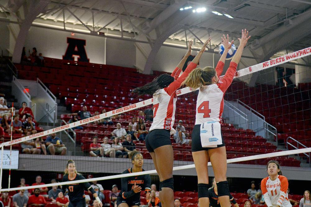 Freshman middle back Pam Chukwujekwu senior setter Kylie Pickrell jump to block a ball. Chukwujekwu had 2 spikes and Pickrell had 32 set assists as the Wolfpack defeated Campbell 3-0 at Reynolds Coliseum on Sunday, Sept. 9.