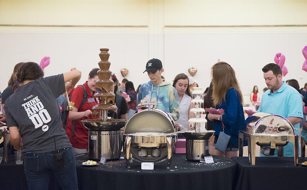 Guests of the Chocolate Festival dip fruits and treats into a chocolate fountain at Talley Student Union on Friday, Sept. 28, 2018. The Chocolate Festival, hosted by the Women's Center, raised money for the Kay Yow Cancer Fund.&#160;&#160;