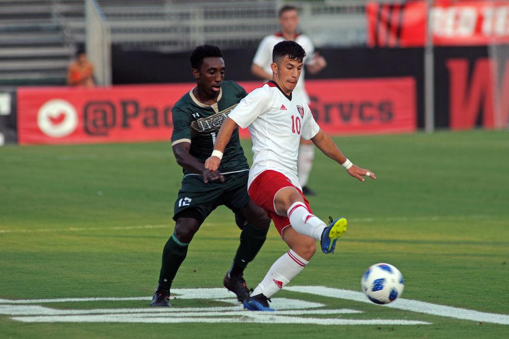 Sophomore forward David Loera battles for the ball against William &amp; Mary on Monday, Sept. 3. N.C. State prevailed over William and Mary in a 2-1 win for the Wolfpack in overtime.